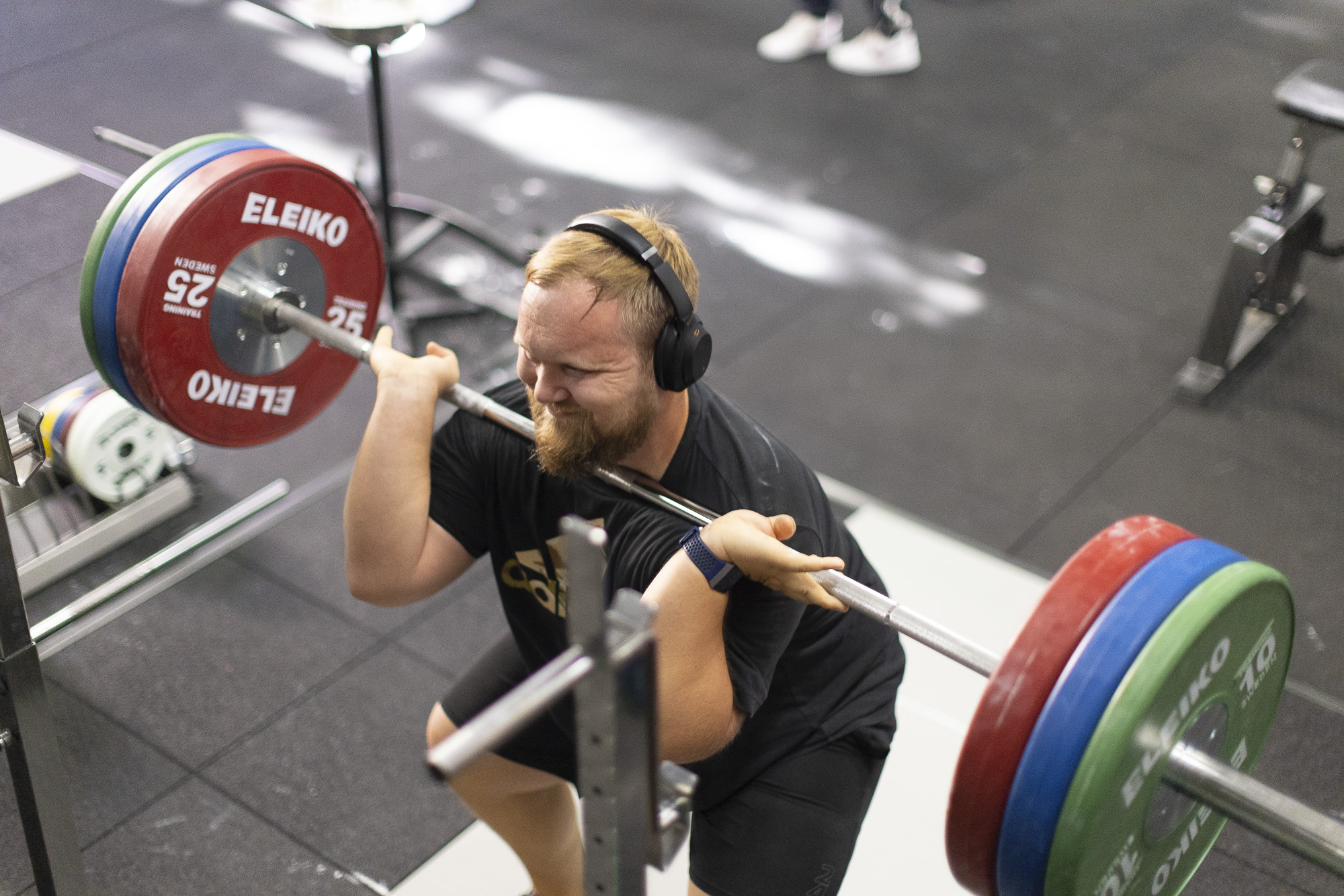 Man Front barbell squatting in the ASU gym