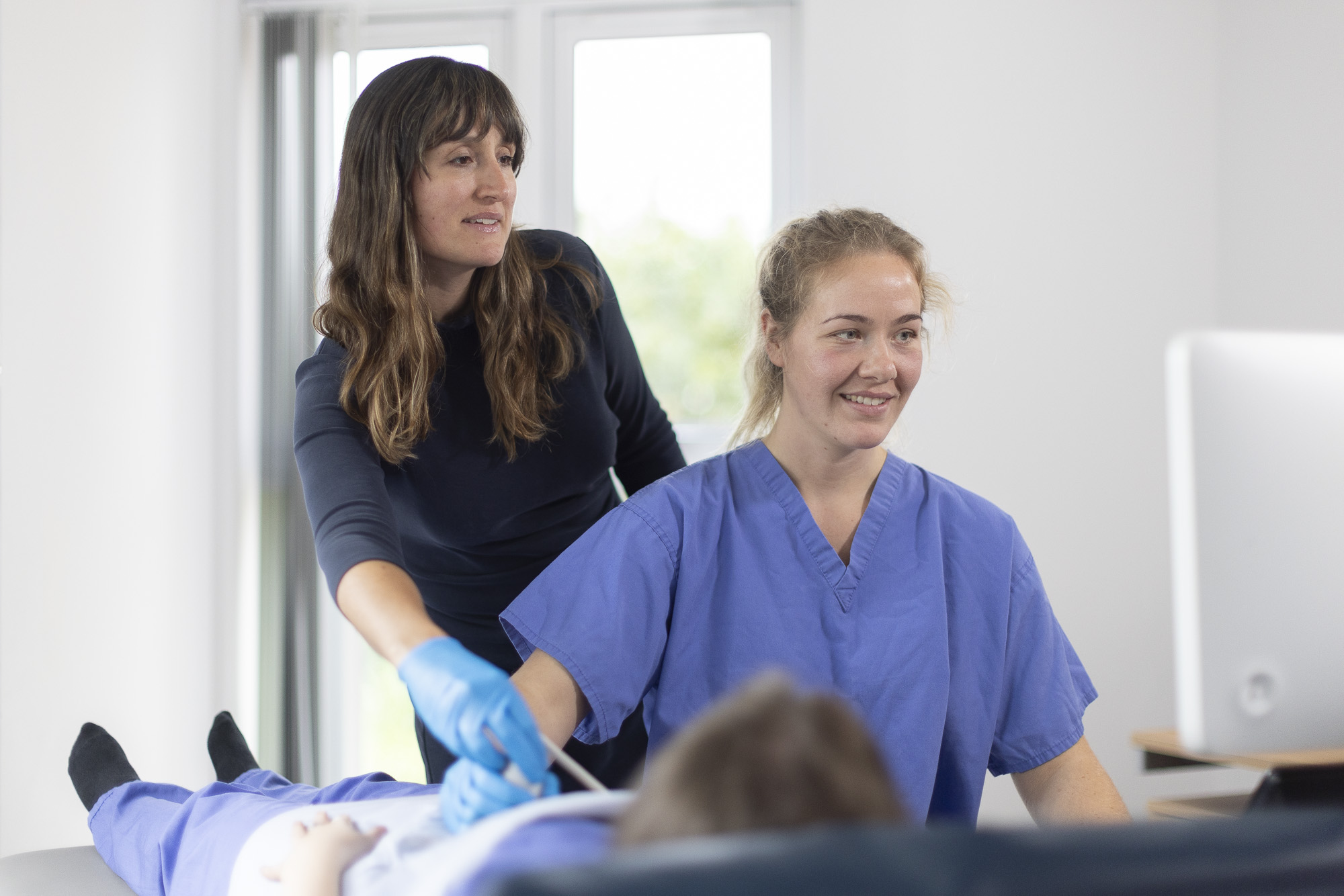 Ultrasound course lead explaining a technique to a student