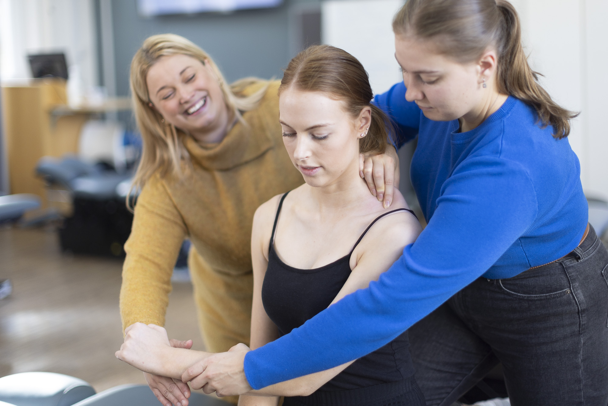 Chiropractic teacher with two students showing them a technique